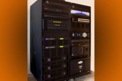 Equipment rack on casters with Meridian processor and three QSC amplifiers