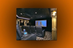 Home theater with a star ceiling, ceiling-mounted projector, paneled walls and black leather recliners