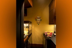 Theater snack bar with a popcorn machine, popcorn buckets and a diner-style sign