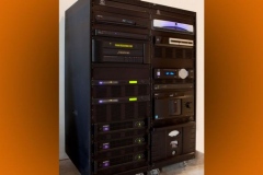 Equipment rack on casters with Meridian processor and three QSC amplifiers